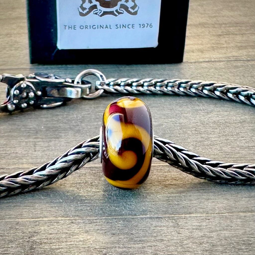 Suzie Q Studio's "ORNAMENT" bead was part of the Trollbeads "Tibet Beads" Collection. This striking bead is a tribute to Tibetan culture. Check out Suzie Q Studio's entire collection of new, never worn Rare & Retired Trollbeads.