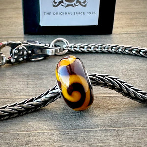 Suzie Q Studio's "ORNAMENT" bead was part of the Trollbeads "Tibet Beads" Collection. This striking bead is a tribute to Tibetan culture. Shop online for one-of-a-kind treasures at Suzie Q Studio.