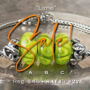 Three versions of glass LIME Trollbead, triangle & bubble design, in tones of bright green, on Trollbeads silver bracelet.