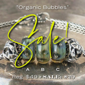 Three versions of glass ORGANIC BUBBLES Trollbead, with bubbles & organic, natural colors, on a Trollbeads silver bracelet.