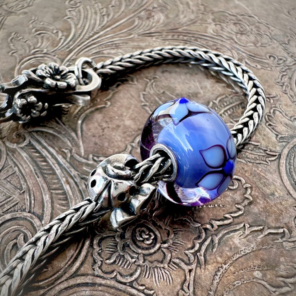 Suzie Q Studio's beautiful limited edition Trollbeads "GOOD LUCK" Starter Bracelet includes: a sterling silver "messenger of good luck" bead, a gorgeous glass bead with the flower of Love, and a ladybug lock as well as a Trollbeads classic foxtail-chain bracelet.