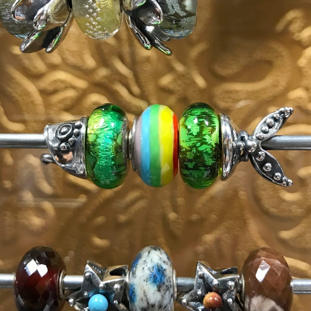 Trollbeads, JEWEL OF SEA, sterling silver, two-part pendant of a fish, shown on a Trollbeads bracelet with a glass bead in between the two parts.