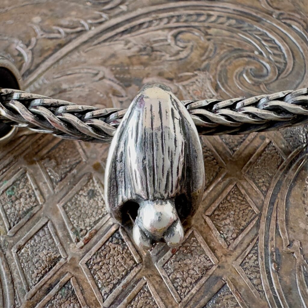 Trollbeads sterling silver SLEEPING BAT bead, hanging upside down from a sterling silver Trollbeads bracelet chain.