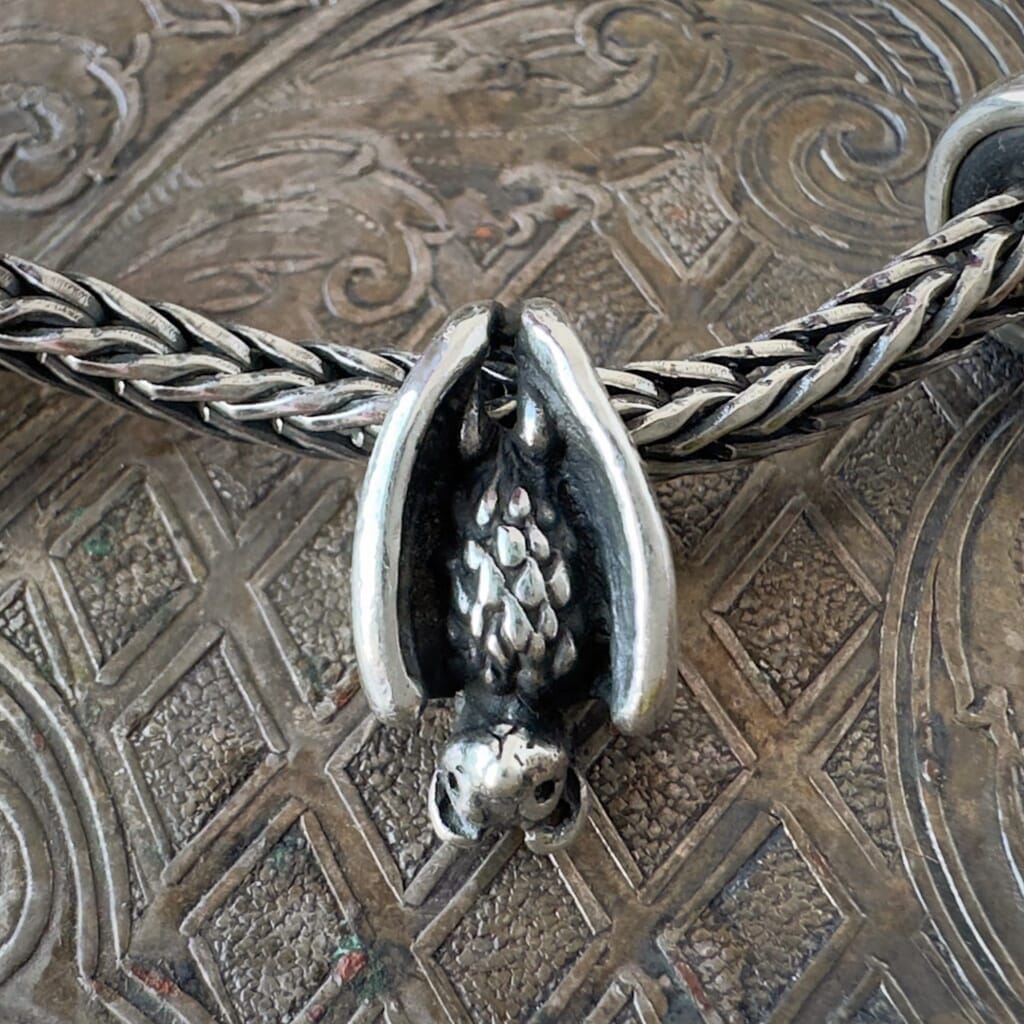 Trollbeads sterling silver SLEEPING BAT bead, hanging upside down from a sterling silver Trollbeads bracelet chain.